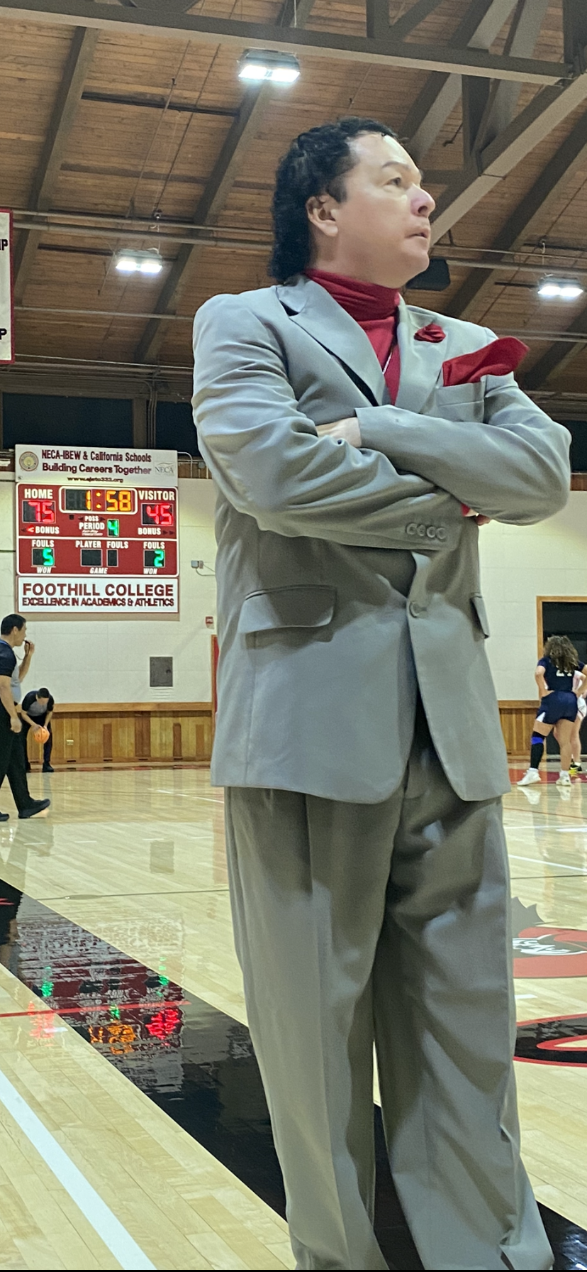 Foothill College women's basketball coach Corey Cafferata walks the sideline during a game.