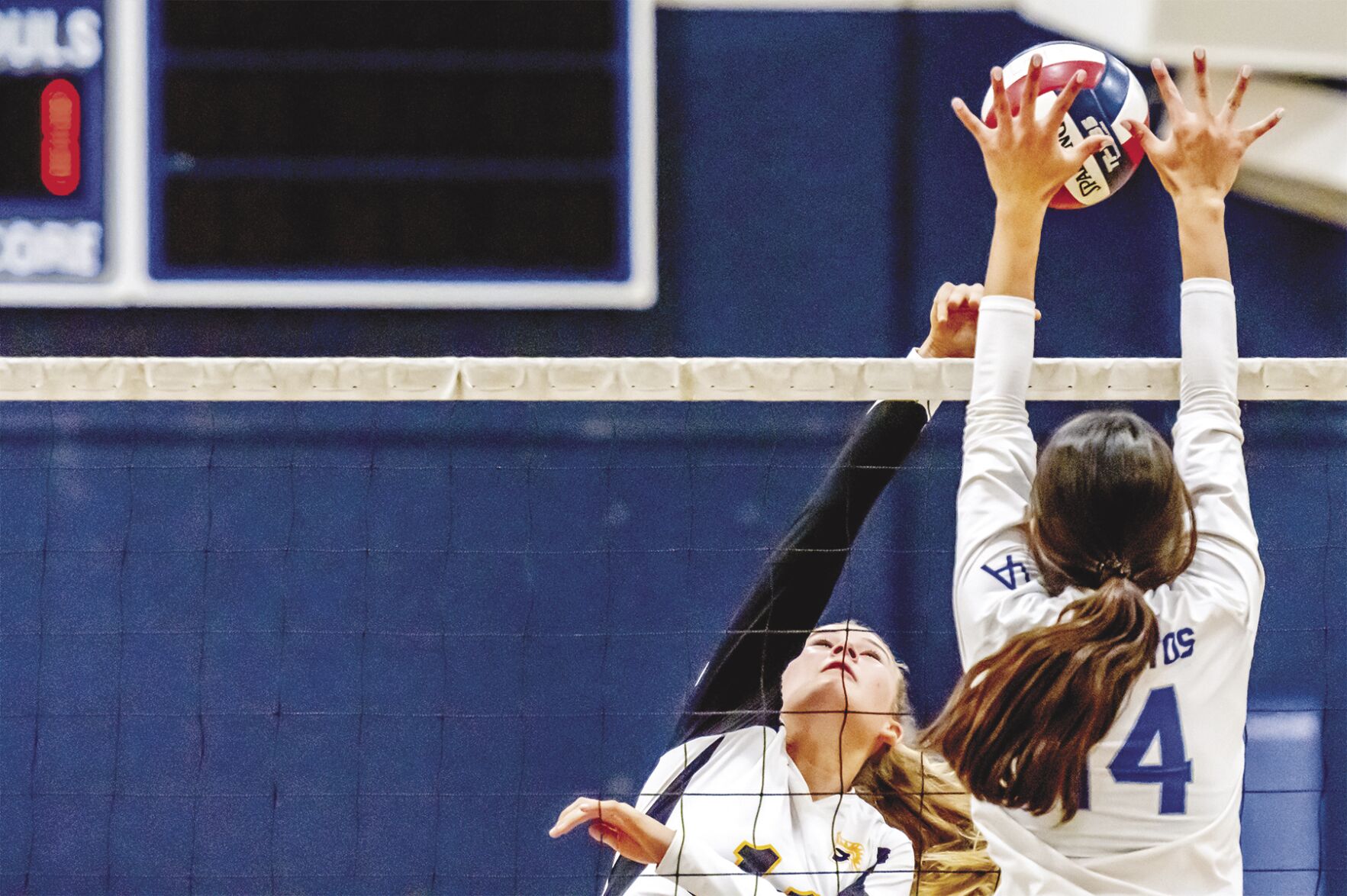 Mountain View High’s Emmy Thomander attempts to hit the ball past the block of Los Altos High’s Ella McFarlane Thursday.