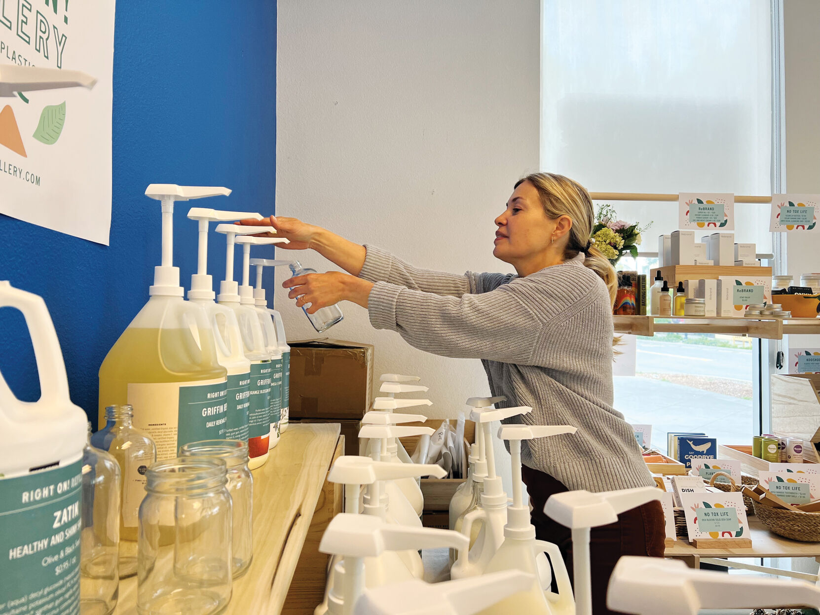 Emily Ting refills bottles at her new downtown Los Altos store, Right On! Refillery.