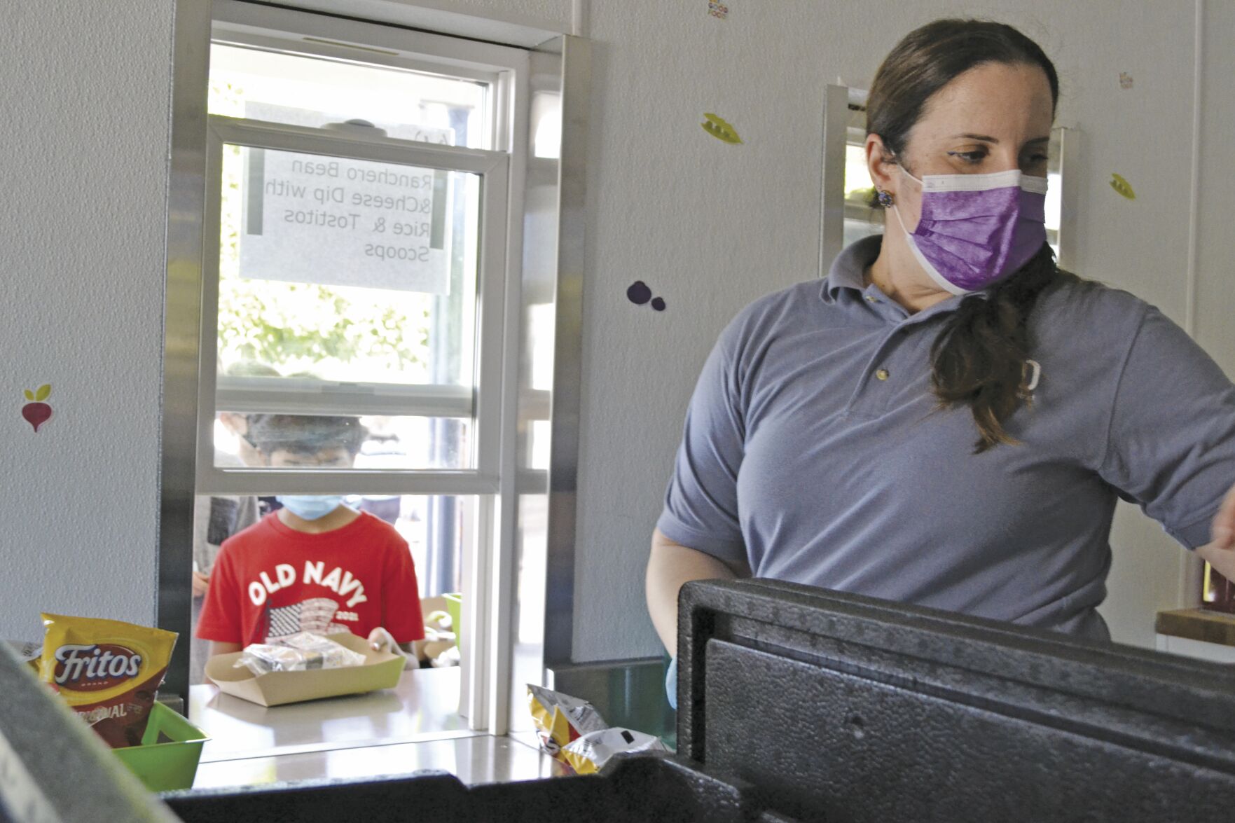 Carly Gomez, above, serves lunch every weekday at Covington School.