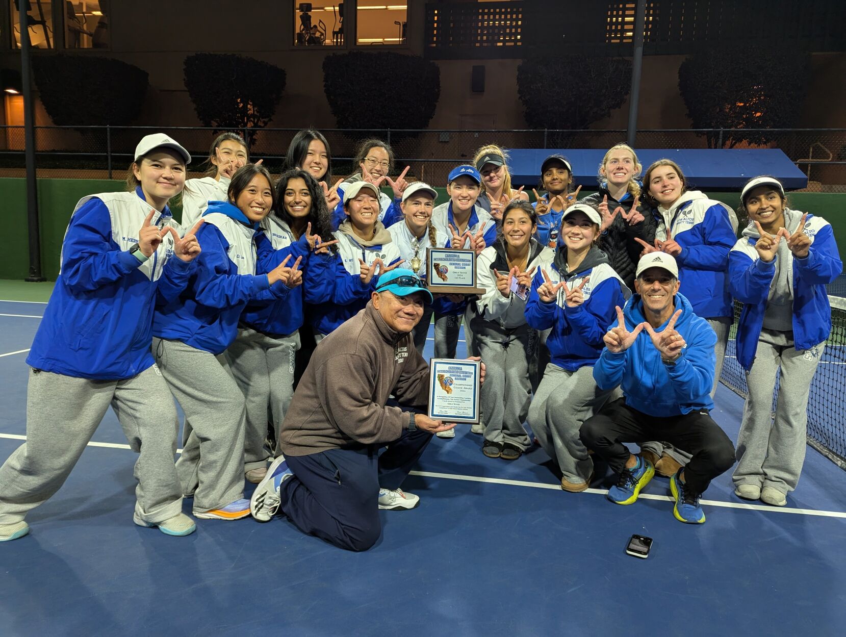 The Los Altos girls tennis team from left to right: Maddie Herby, Daniella Lee, Lucy Lai, Ruhi Bhaskar, Jolie Lu, Emily Wu, Ava Cheng, head coach Hung Nguyen, Tyra Bogan, Carissa Lai, Cory Medeiros, Bella Mariona, Pallavi Mallampati, Emmy Redden, Ava Randall, coach Steve Apfelberg, Sophia Stavrakos and Ayana Modi.