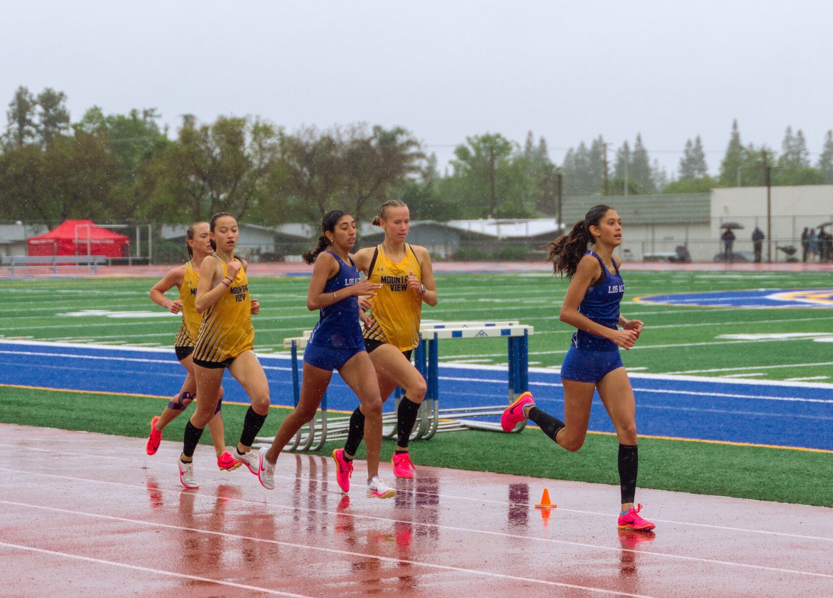 Los Altos and Mountain View runners race during the SCVAL De Anza Division championship meet Saturday. Several events like hurdles, high jump and long jump were moved to Monday.