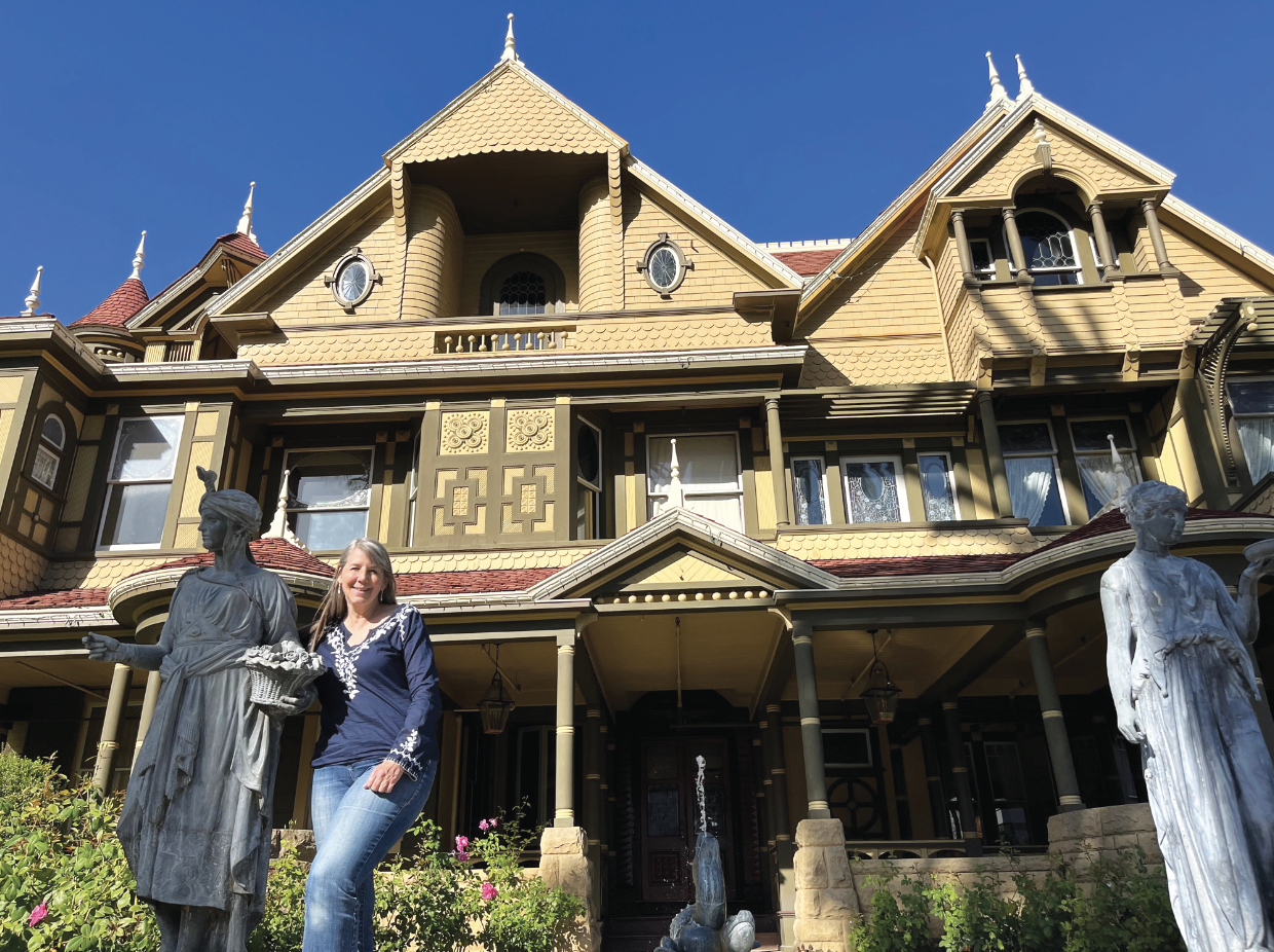 Janan Boehme stands in front of the Winchester Mystery House.