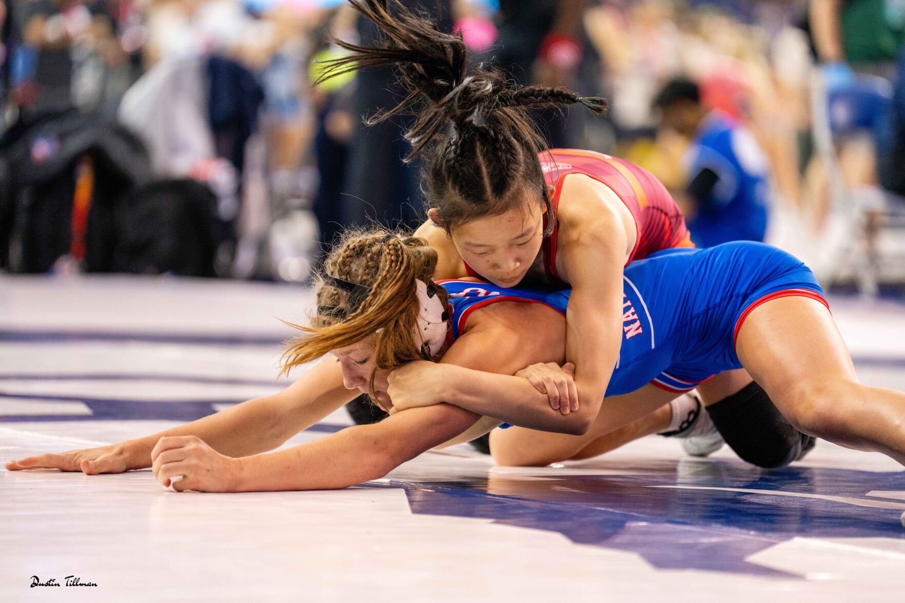 Mountain View junior Kiana Lien, in red, wrestling during the girls 16U Nationals tournament.