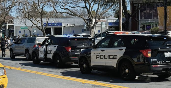 Police stop a car along State Street in Los Altos. Goods stolen from the Discovery Shop were in the car.
