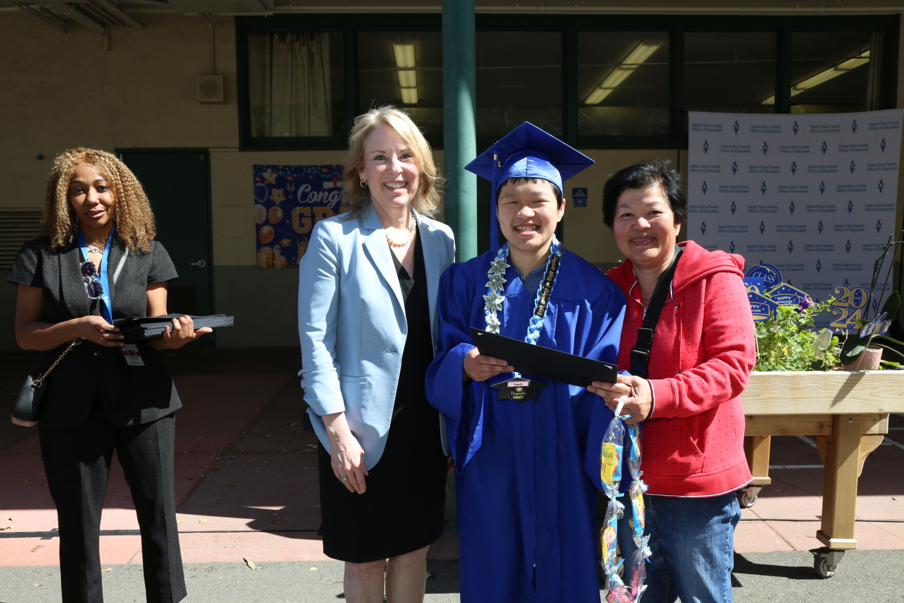 Superintendent Mary Ann Dewan, left, attends a graduation ceremony earlier this year.