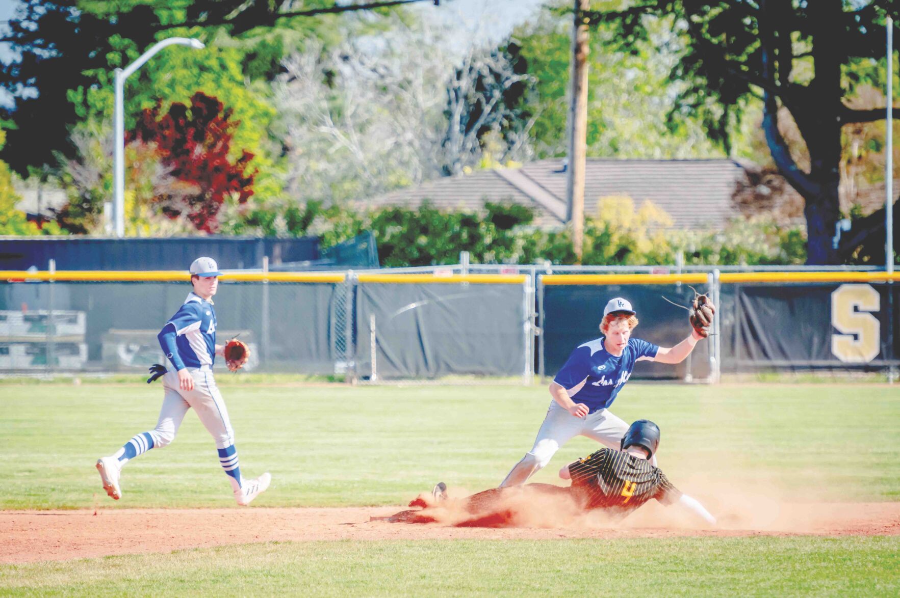 Mountain View High's Kevin Conway slides under Los Altos High second baseman Rowan Sims in last week’s series opener.