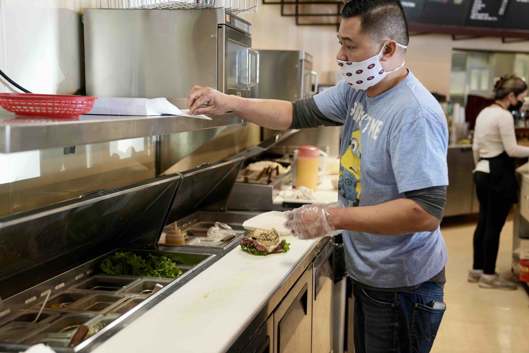 Main Street Bagels’ new owner Sano Tien prepares a bagel sandwich. He previously worked at Los Altos Bakery, a former business also located at Rancho Shopping Center.