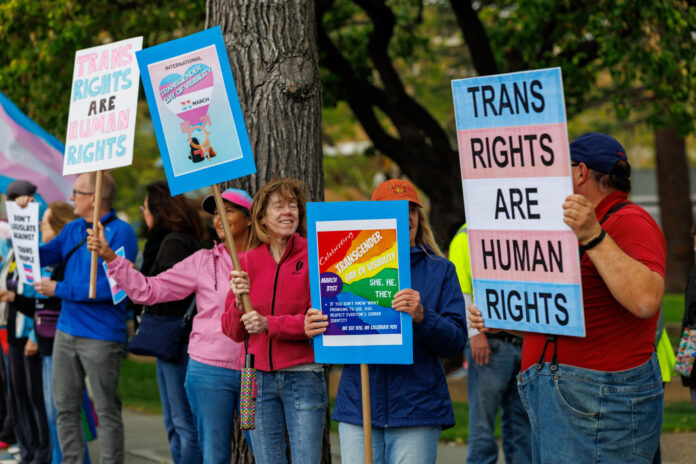 Demonstrators rally Tuesday on El Camino Real in Mountain View for Transgender Day of Visibility.