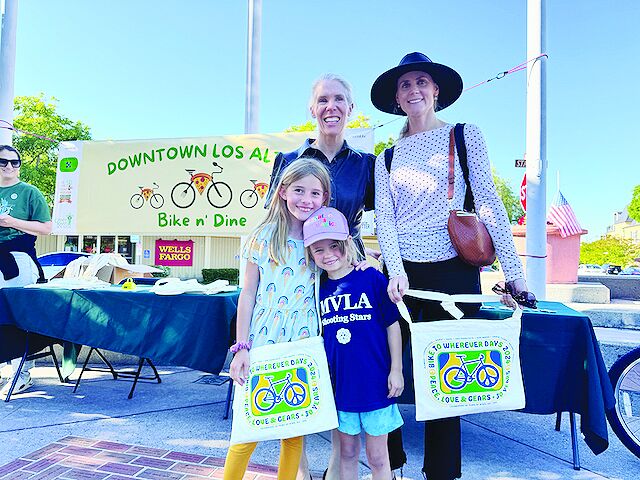 Families show off their swag bags from 2024’s Bike n’ Dine event in downtown Los Altos.