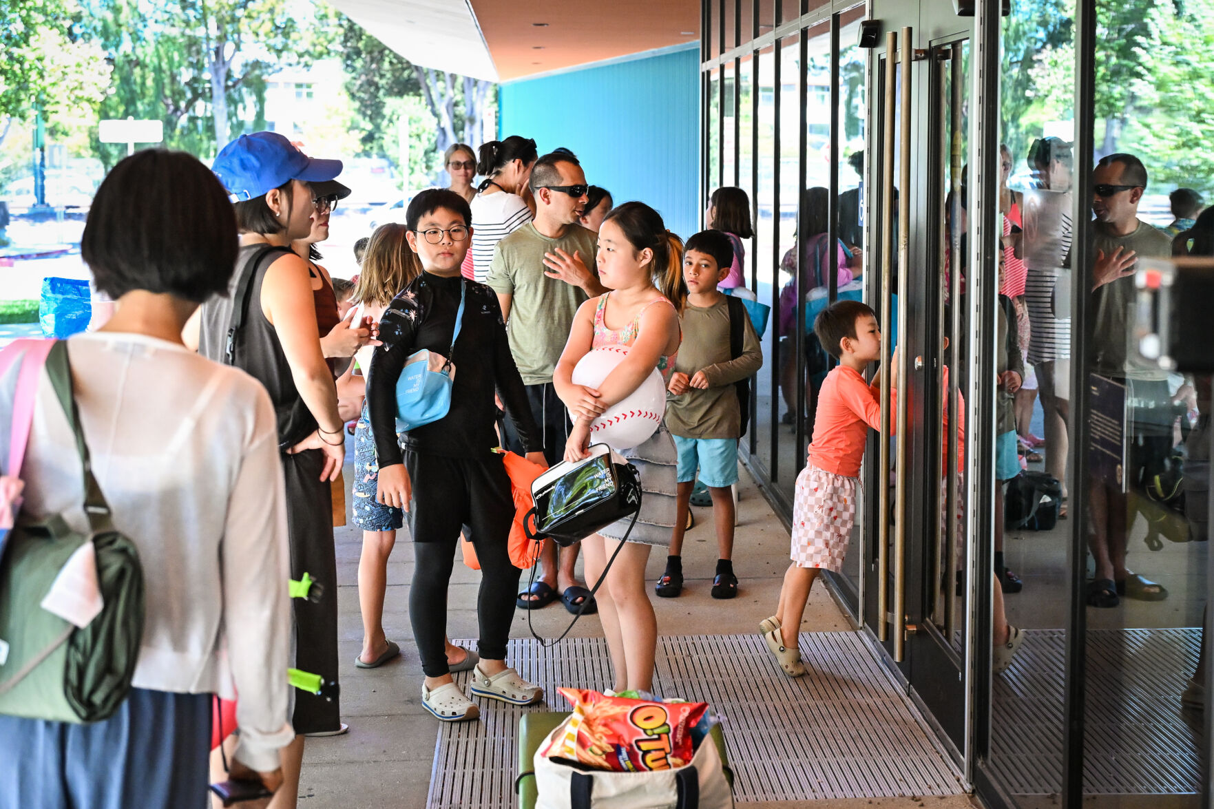 Alvaro Baraona and his son Santi, age 9, were among the roughly 30 people waiting for the Rengstorff Park Aquatics Center’s activity pool in Mountain View to reopen at 2:30 p.m. today. Baraona said they have swum at the pool for the last three summers and during the 11-day closure, they swam at the Eagle Park Pool, but prefer the activity pool. “We are happy,” he said. “This is what we were looking for.”
