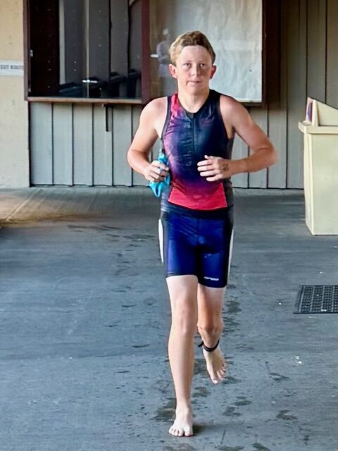 Jack Dickins competes in a triathlon.