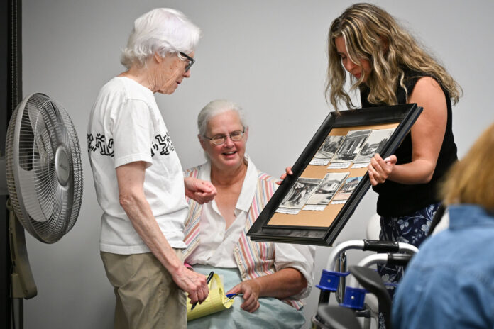 Los Altos Hills Associate Engineer and Project Manager of Heritage House Renovation Melissa Elian-Carrillo shares historic photos that will soon be on display at the Heritage House with members of the History Committee.